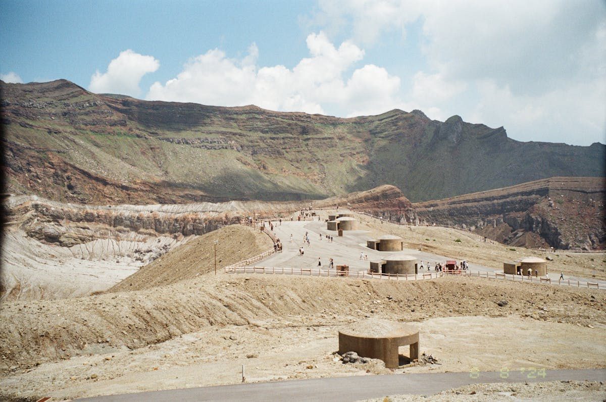 Tourists walking around the crater viewpoint area at Mt Aso Japan