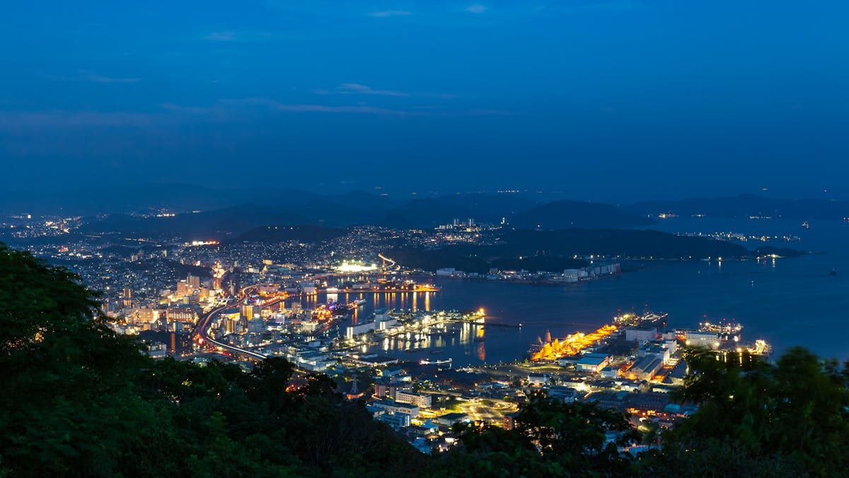 Nagasaki harbour at night with illuminated cityscape