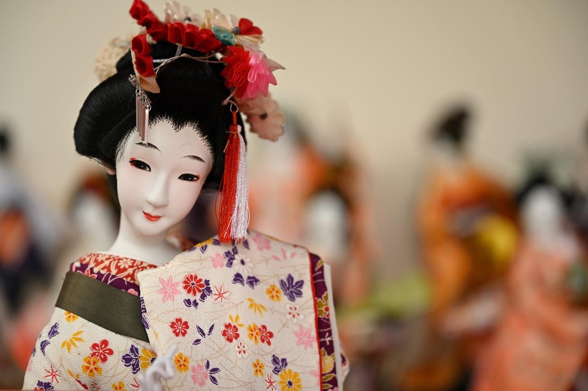 Japanese doll wearing traditional kimono with delicate features