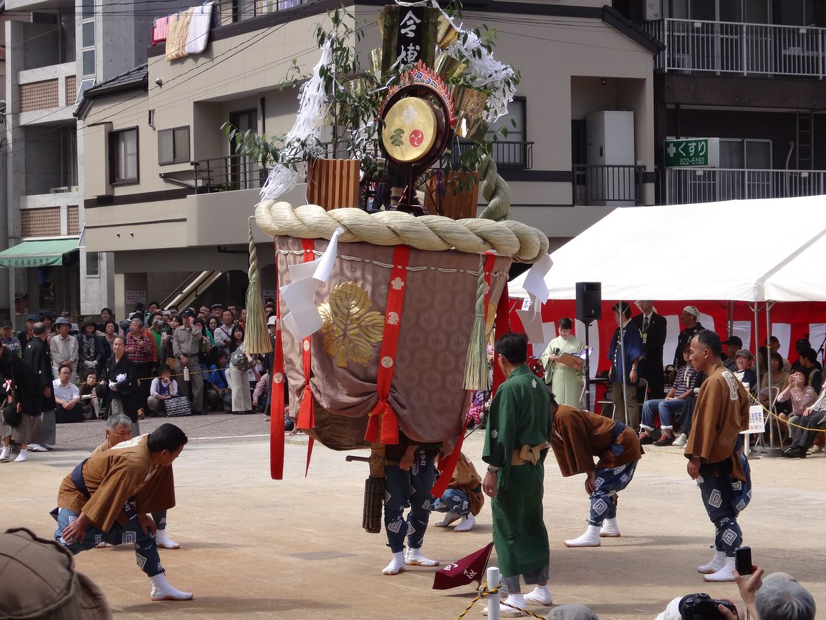 Ornate festival float being carried through the streets during Nagasaki Kunchi