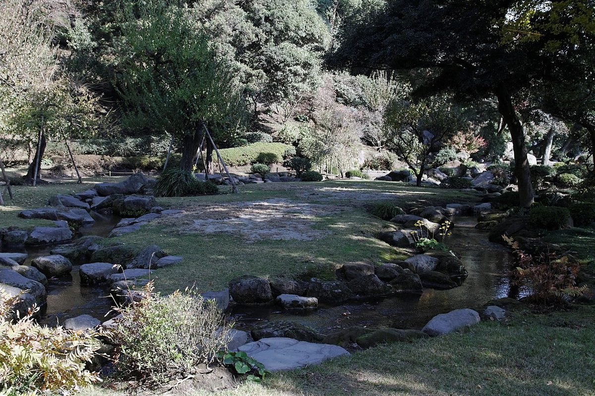 Sake cups floating on small boards in the meandering stream of a Kyokusui garden