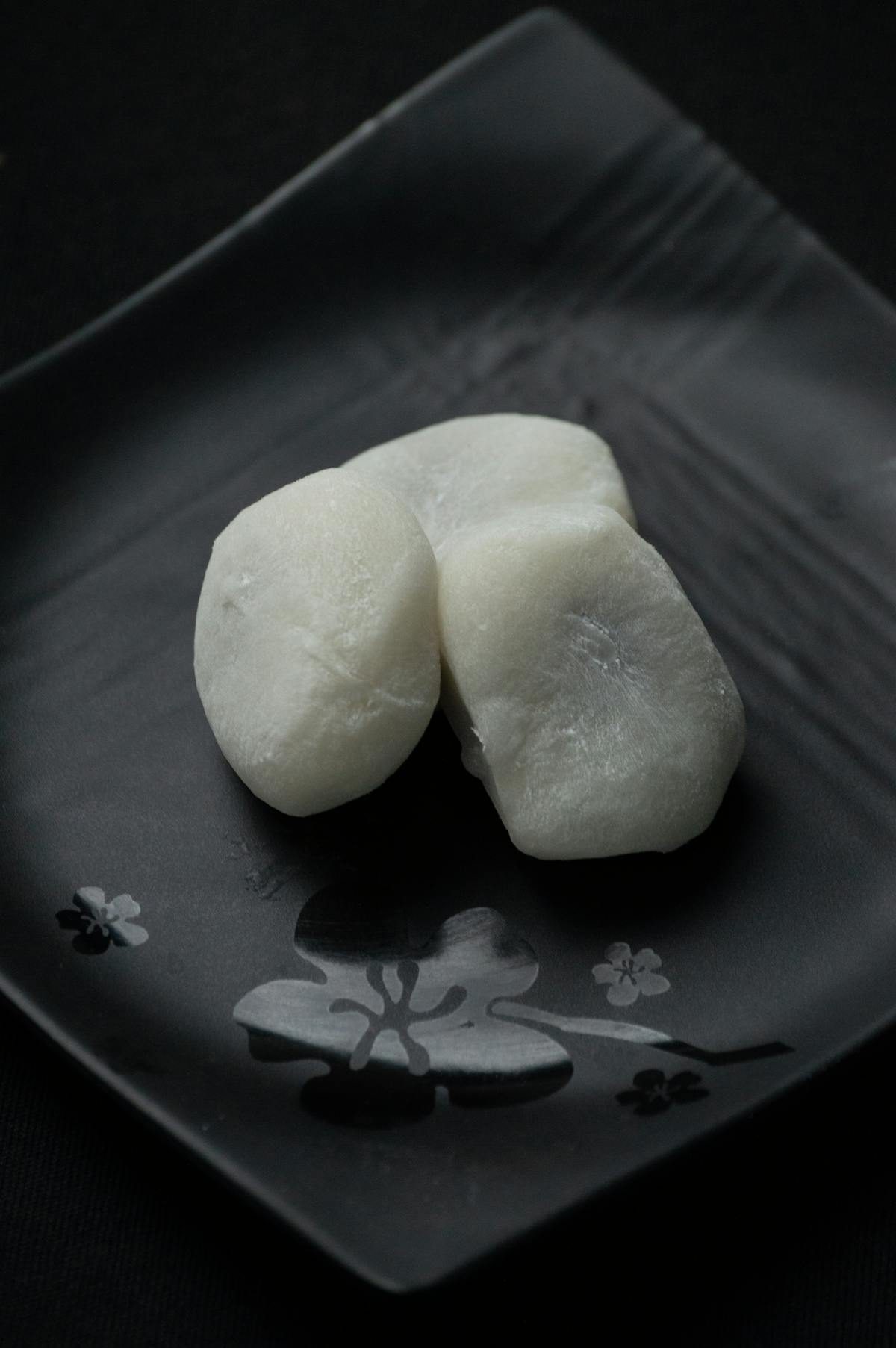 Traditional Japanese mochi rice cakes on a decorative plate