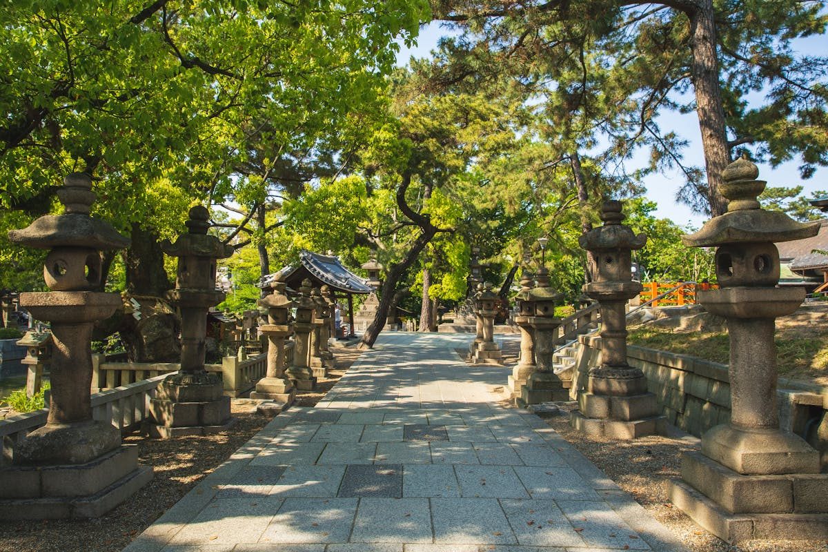 Traditional stone lanterns lining a pathway at Dazaifu Tenmangu