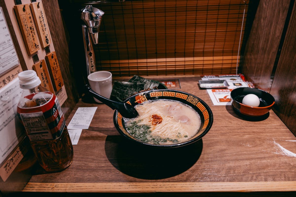A steaming bowl of ramen served in a private dining booth