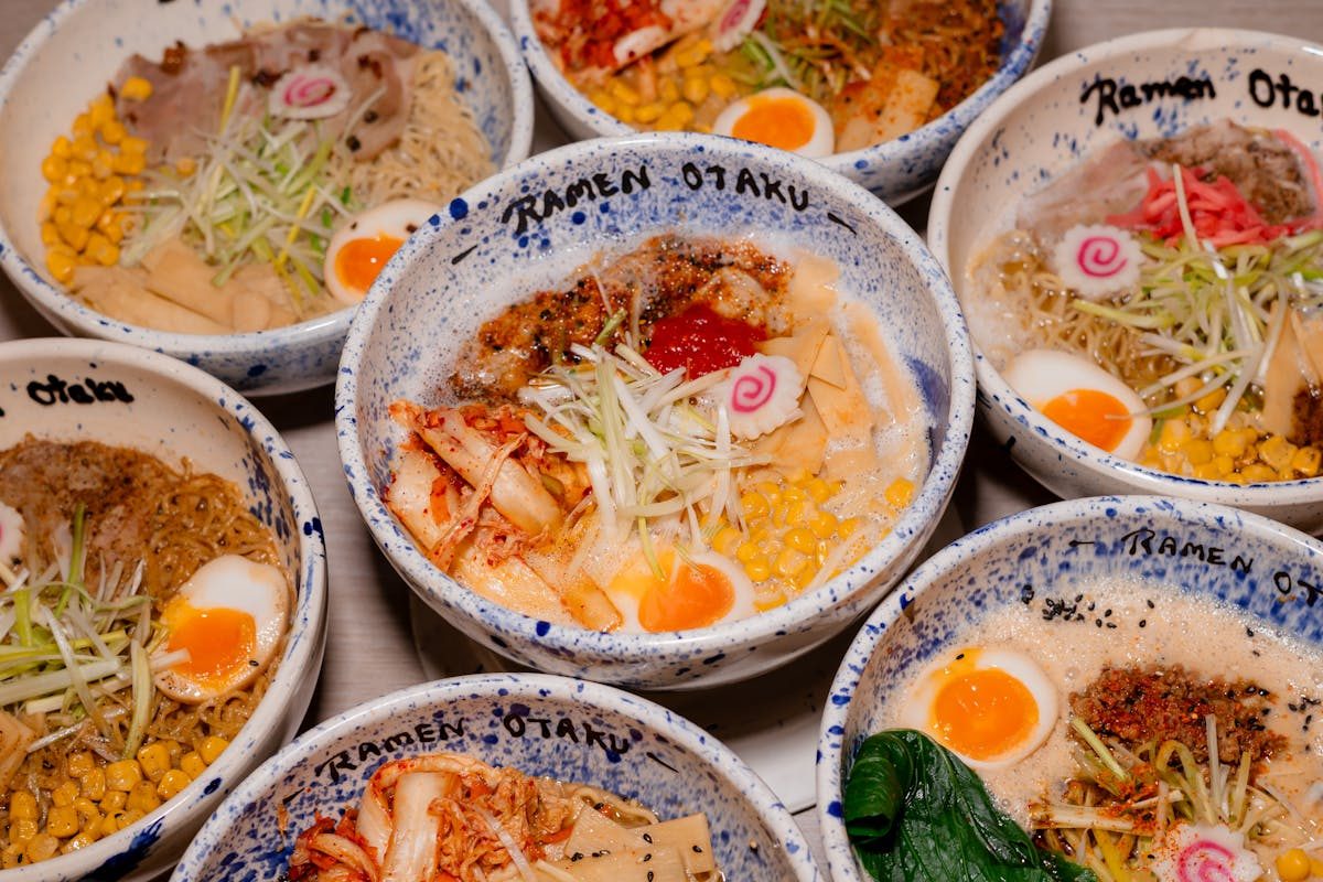 Multiple bowls of Japanese ramen with various toppings