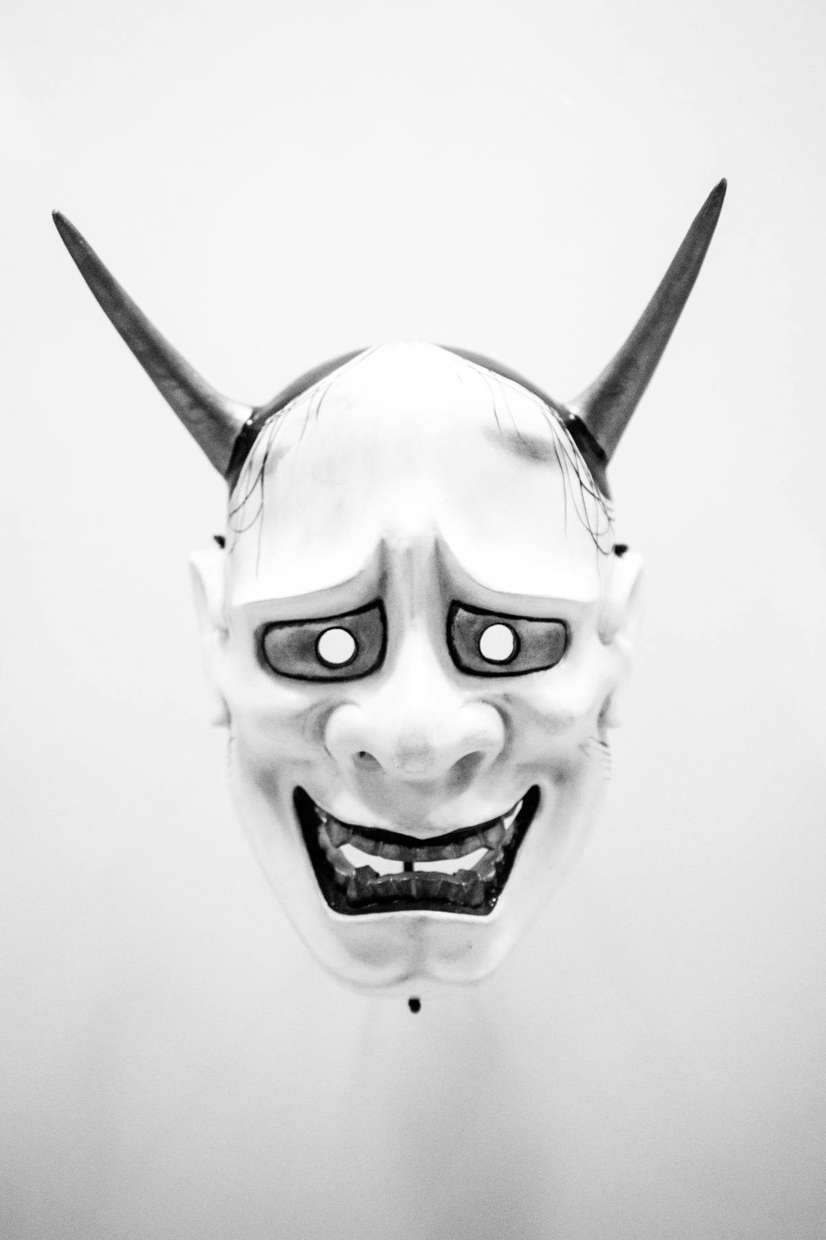 Traditional Japanese demon mask with horns used in Noh and festival performances