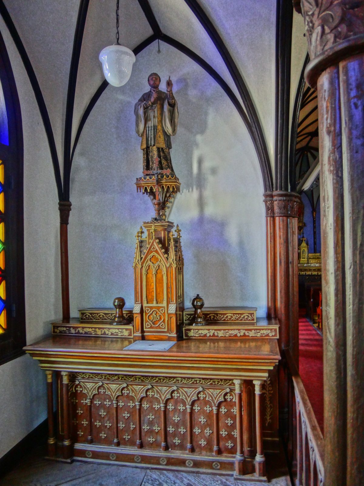 Gothic arched interior of Oura Church with red carpet aisle in Nagasaki